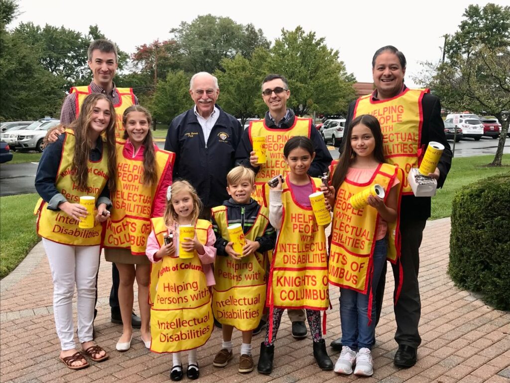 Mater Dei Knights and their families in yellow aprons collecting donations for the Tootsie Roll Drive